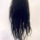 Uncanny girl doll with long dark brown hair. Backside.