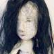 Uncanny girl doll with long dark brown hair.
