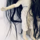 Uncanny girl doll with long dark brown hair.