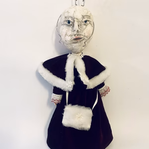 Hacked doll with a Kilner jar clip around its 'ugly' uncanny head.