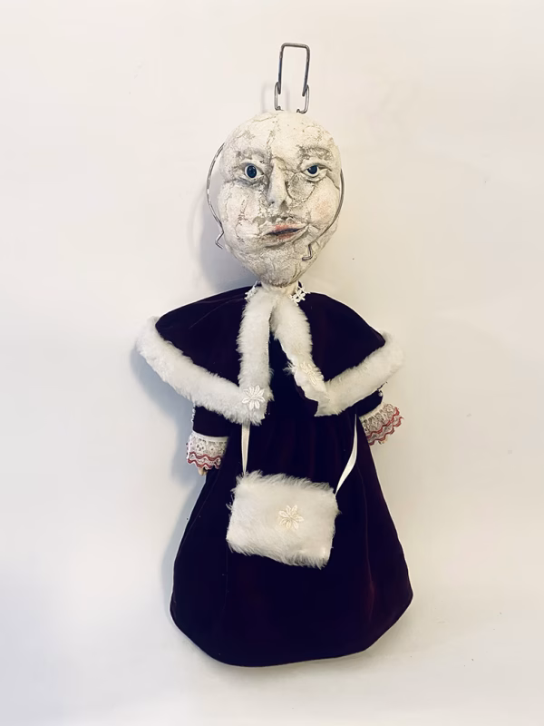 Hacked doll with a Kilner jar clip around its 'ugly' uncanny head.