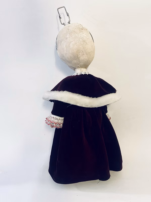 Hacked doll with a Kilner jar clip around its 'ugly' uncanny head.