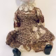 Hacked doll with decayed silk dress. The original ‘pretty’ head is replaced with an oversized, bald, uncanny head.