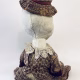 Hacked doll with decayed silk dress. The original ‘pretty’ head is replaced with an oversized, bald, uncanny head.