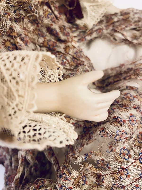 Doll with decayed silk dress.