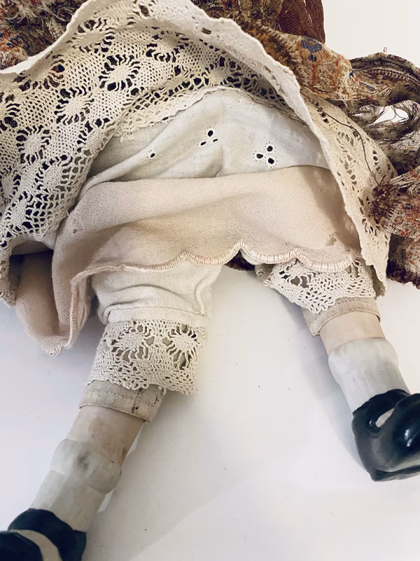 Doll with decayed silk dress.