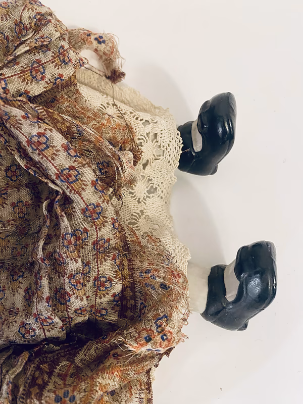 Doll with decayed silk dress.