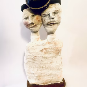 Double headed skeletal torso sculpture crowned with a vintage mechanical hubodometer