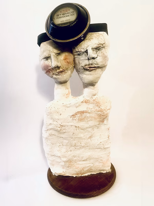 Double headed skeletal torso sculpture crowned with a vintage mechanical hubodometer