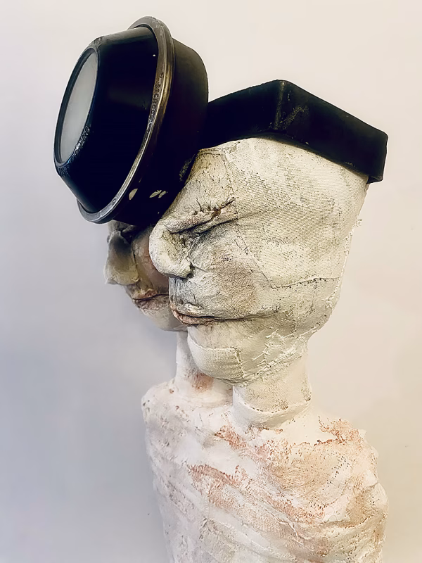 Double headed skeletal torso sculpture crowned with a vintage mechanical hubodometer