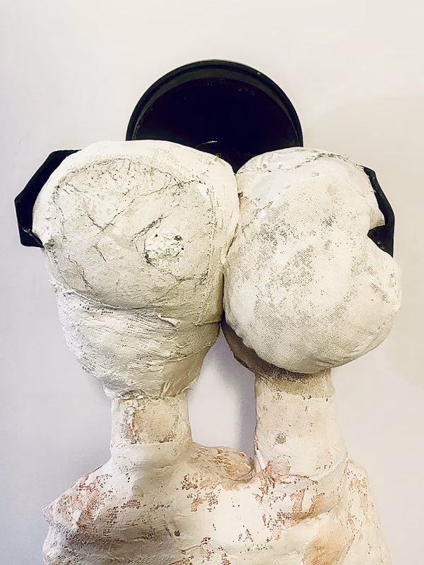 Double headed skeletal torso sculpture crowned with a vintage mechanical hubodometer