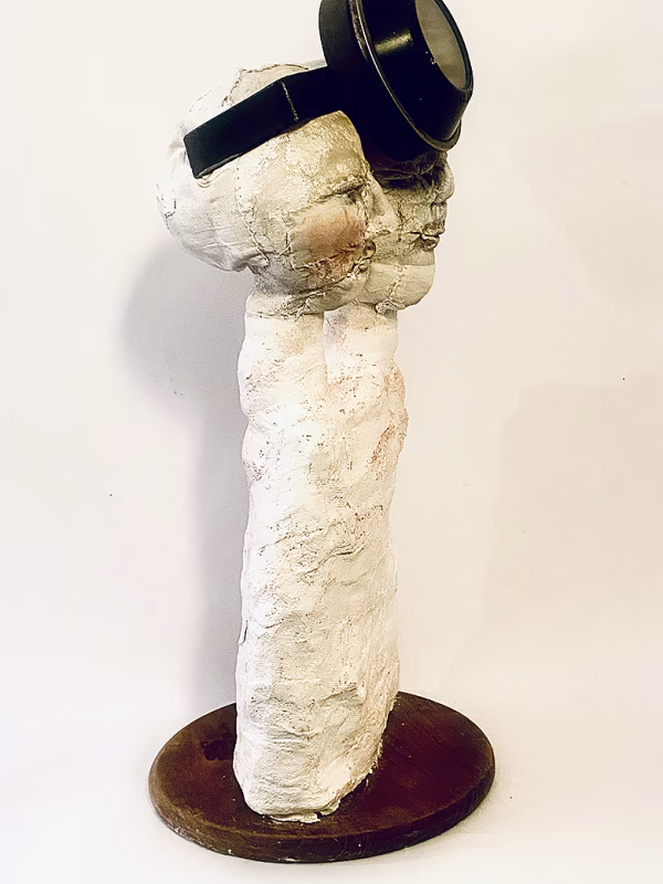 Double headed skeletal torso sculpture crowned with a vintage mechanical hubodometer