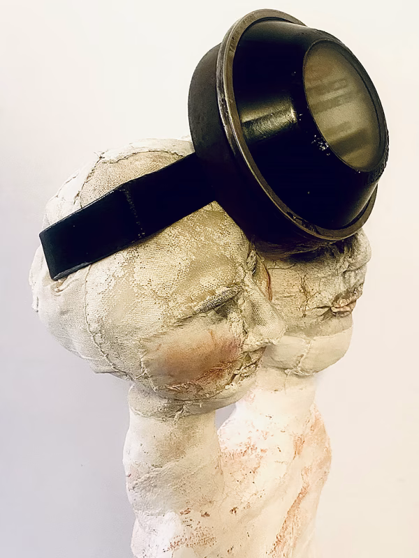 Double headed skeletal torso sculpture crowned with a vintage mechanical hubodometer