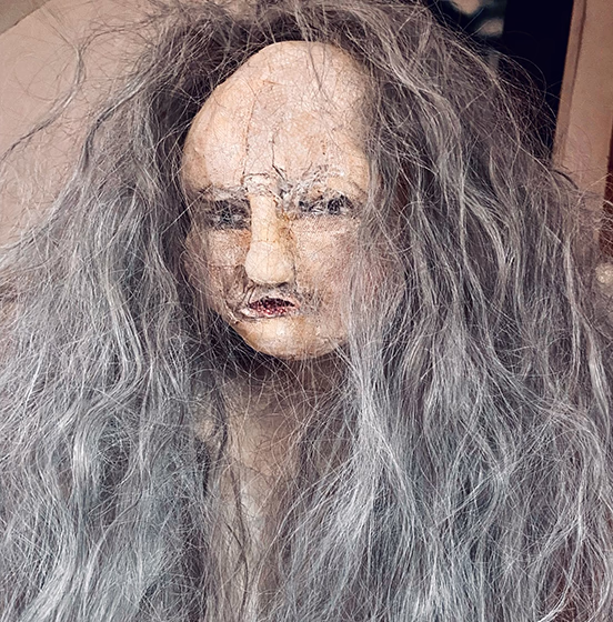 Human figure with long grey hair. Close-up.