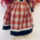 Uncanny girl doll with checkered dress (lower part).