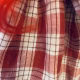 Uncanny girl doll with checkered dress (detail).